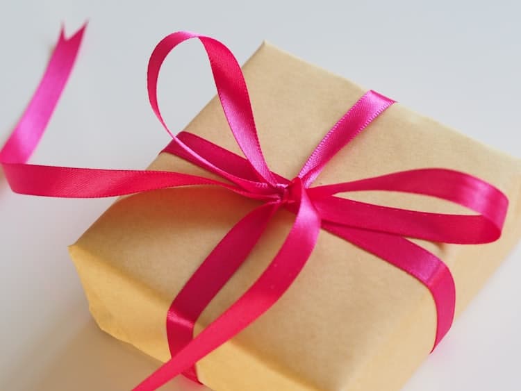 Kraft gift box with a pink ribbon